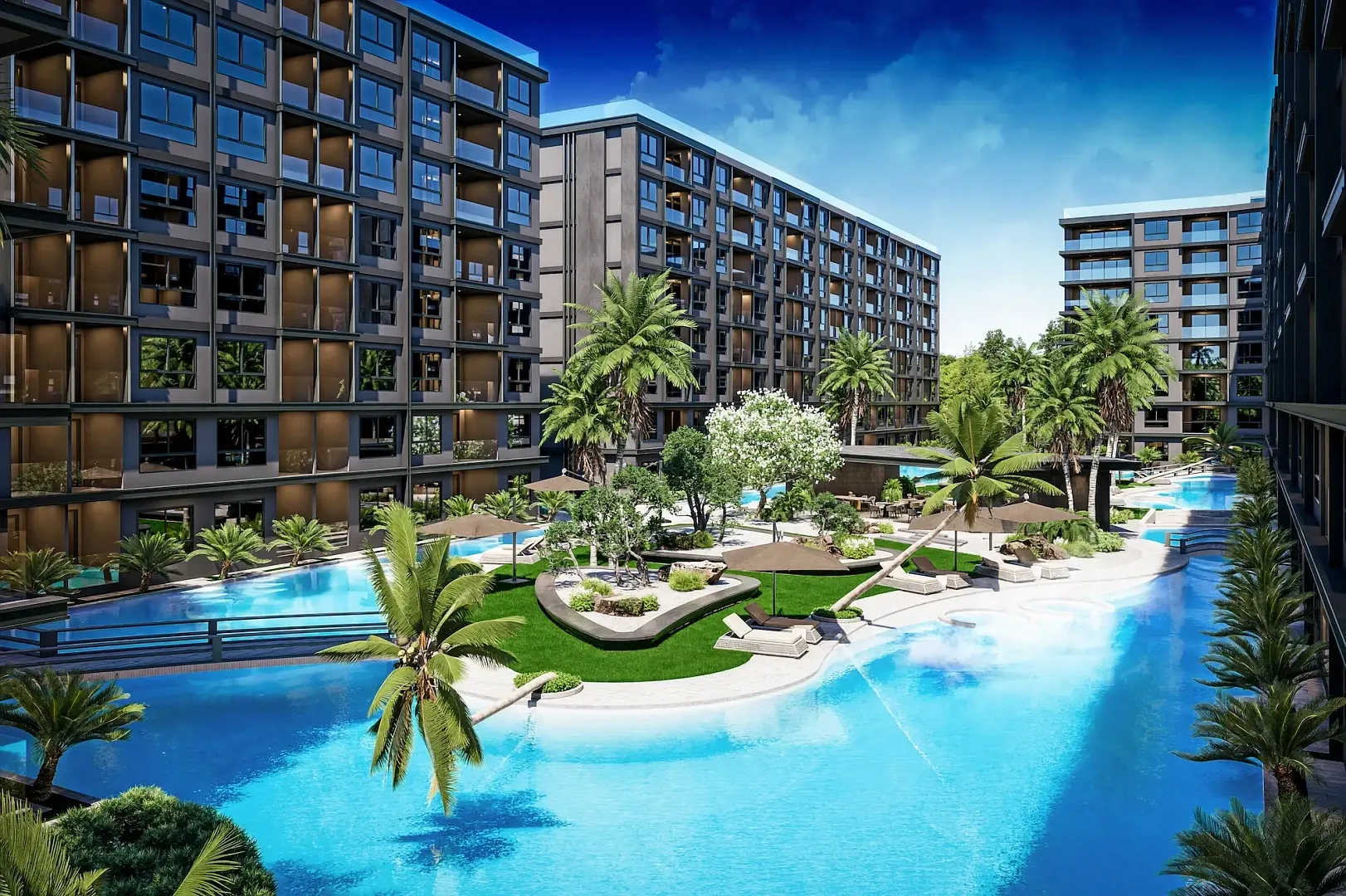 Бассейн с островком и пальмами на закате на территории ЖК Zenith Pattaya II